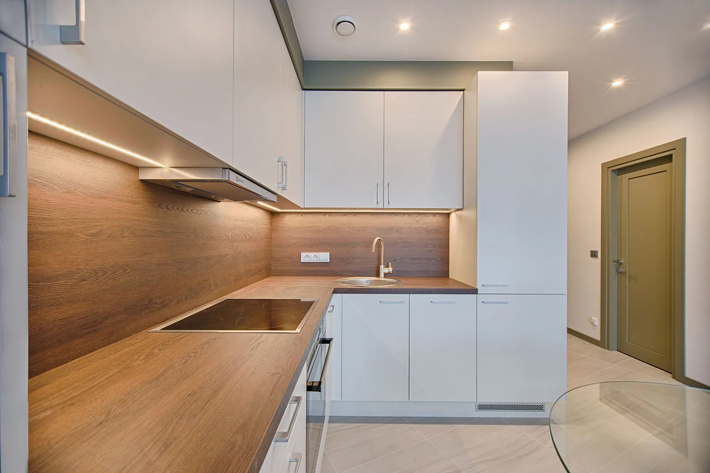 Clear wooden worktop in a white kitchen