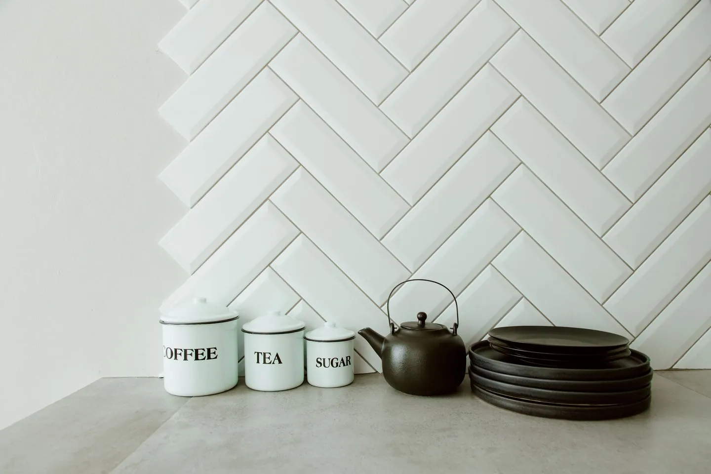Tea, coffee and sugar containers beside a kettle