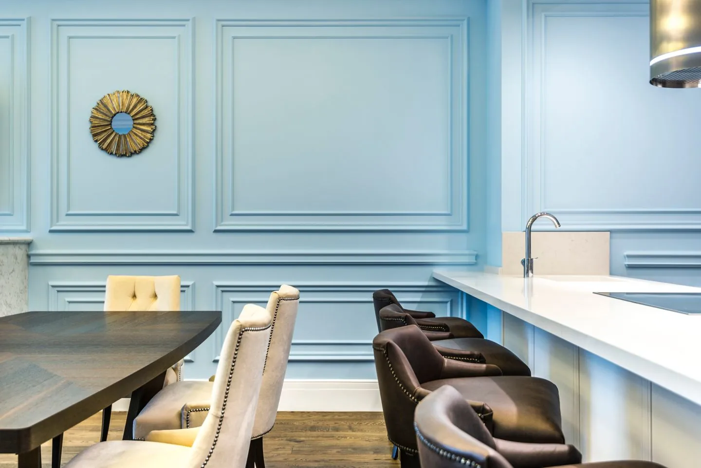 Dining table and chairs against a blue wall
