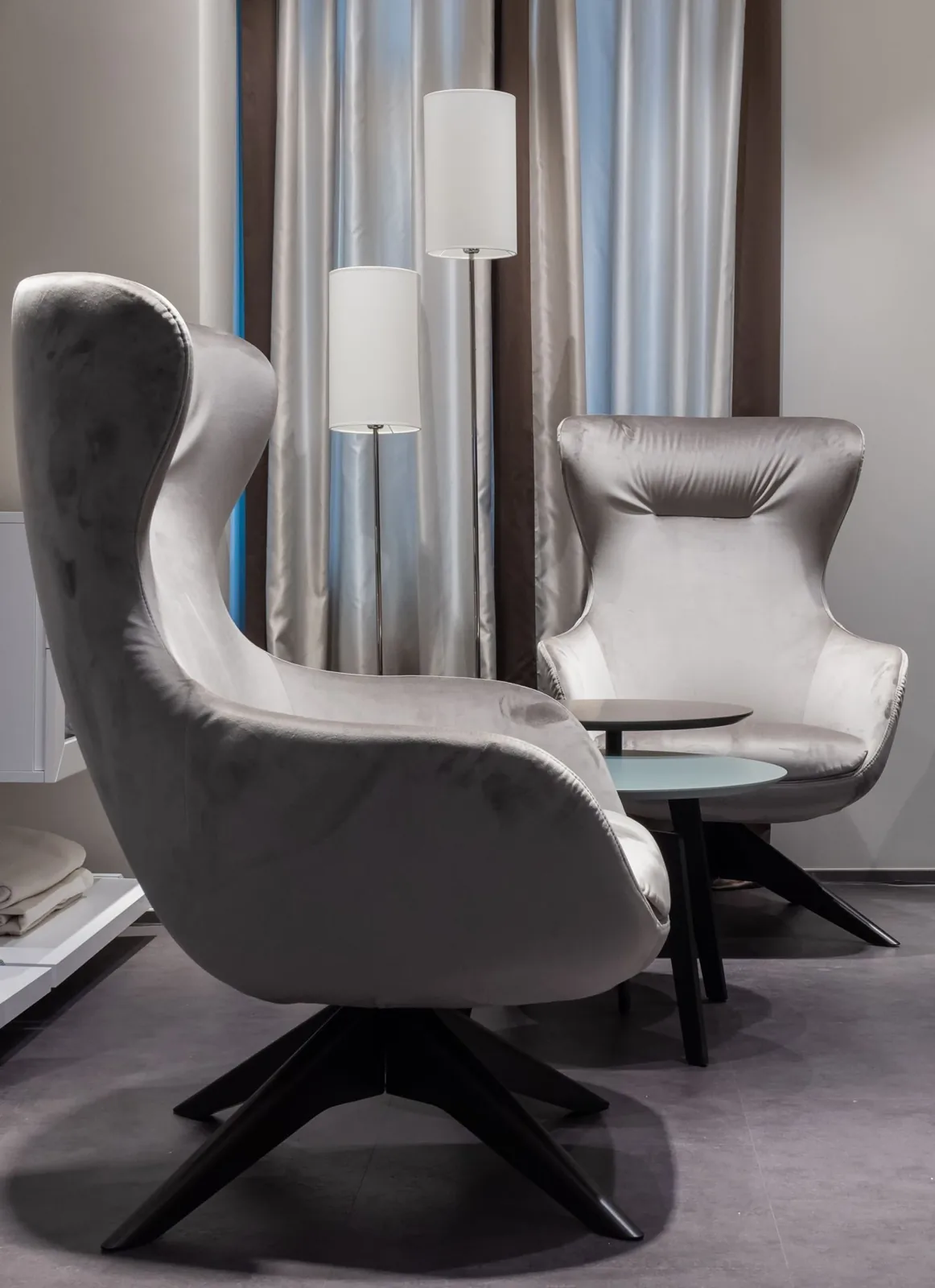 Two upholstered armchairs arranged beside a coffee table