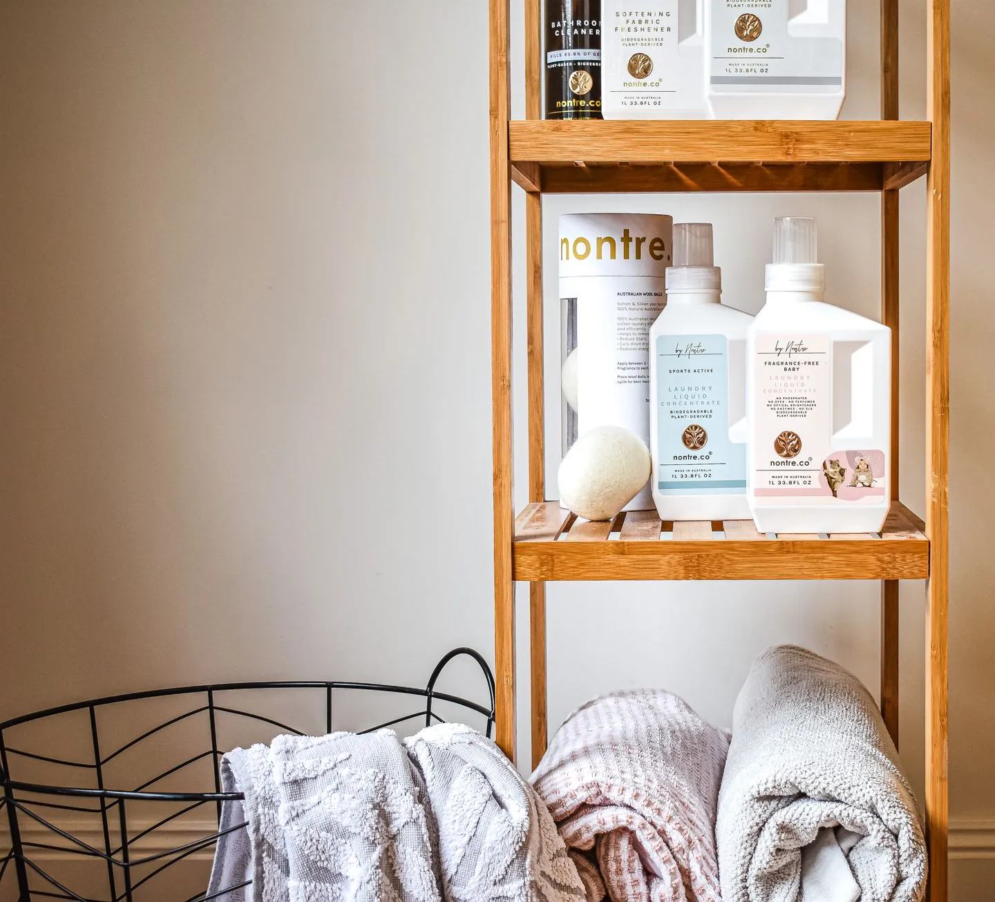 Towels and toiletries arranged on wooden bathroom shelving