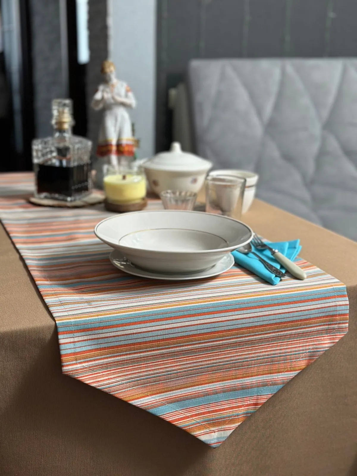Striped table runner beneath a simple place setting