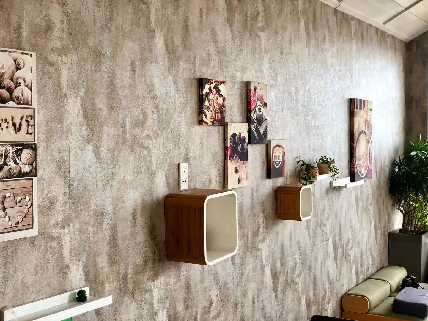 Framed artwork and small display boxes arranged on a wall