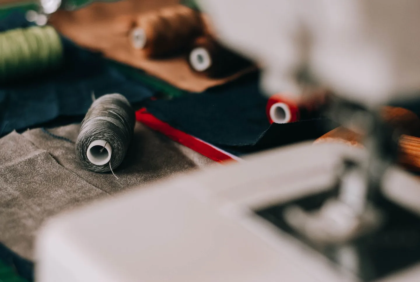 Fabric and thread beside a sewing machine