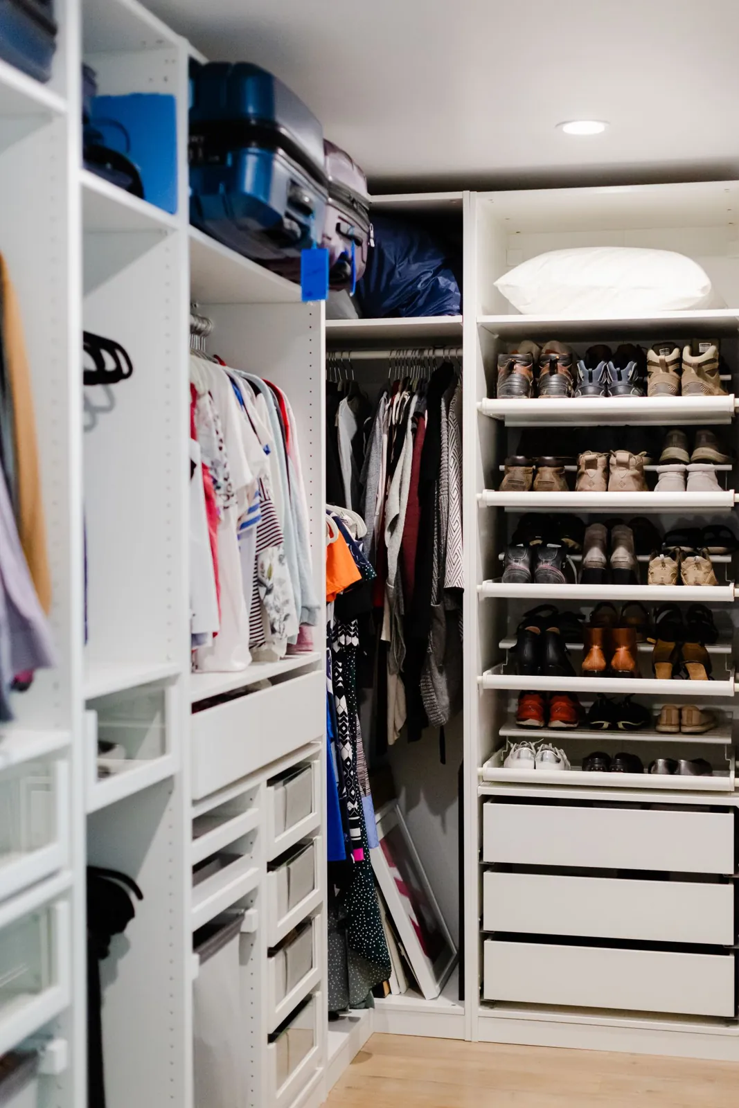 Clothes and shoes arranged inside an open wardrobe