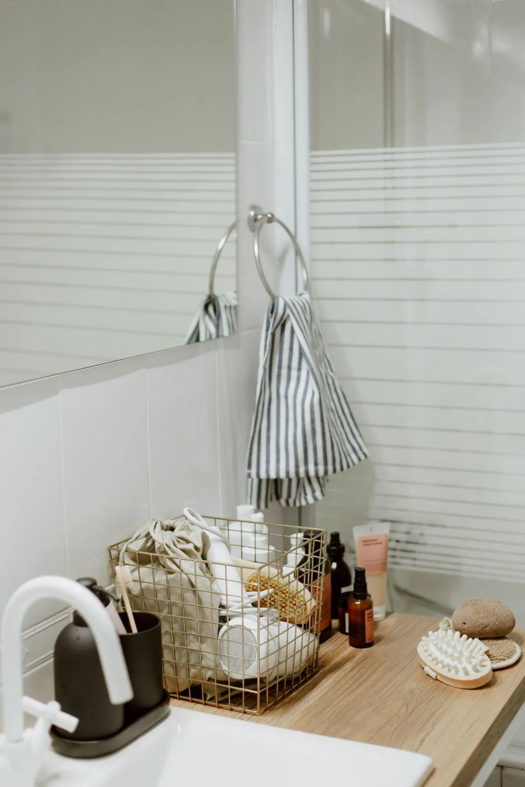 Bathroom basin with a tray of everyday accessories