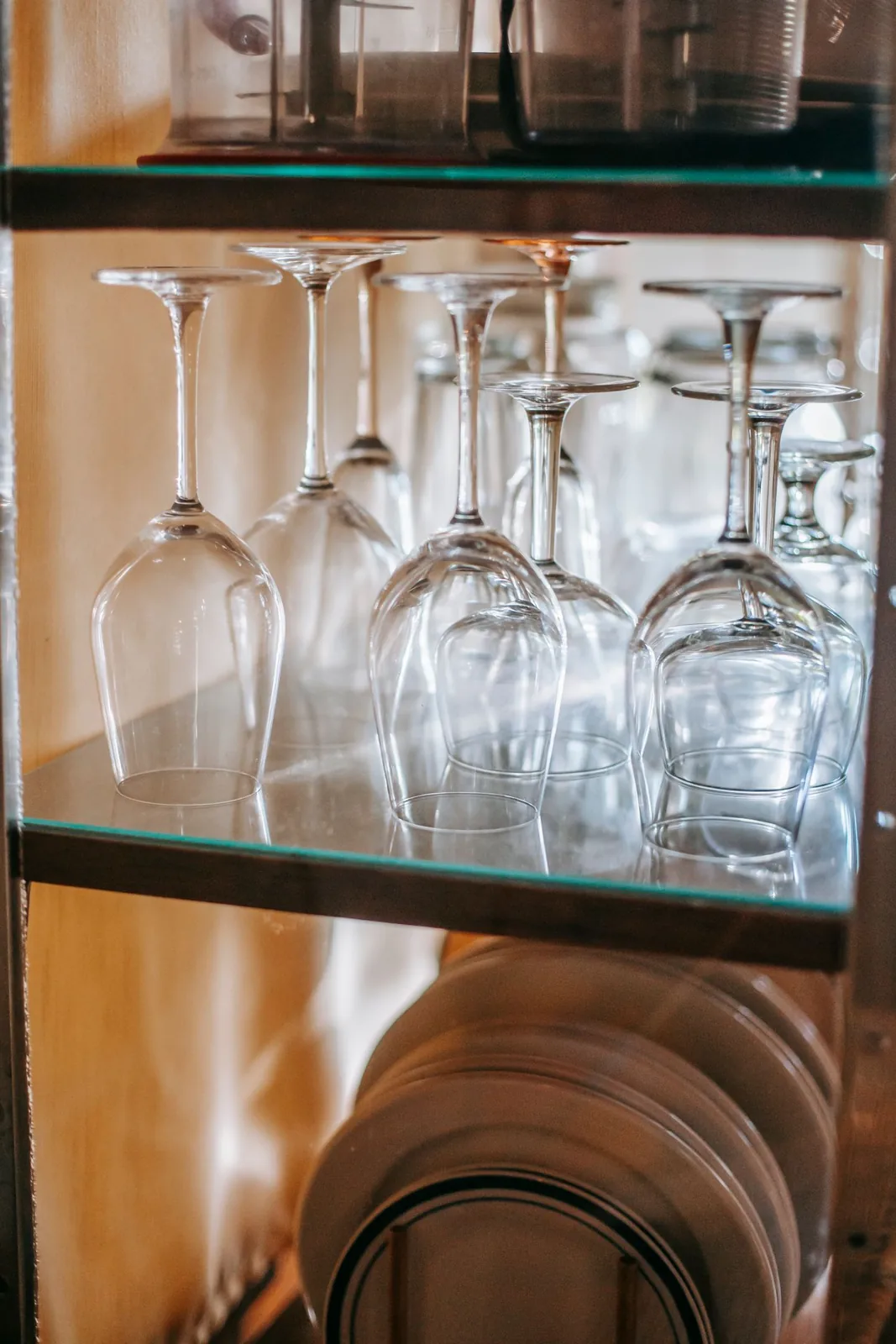 Plates and glassware arranged inside a glazed cupboard