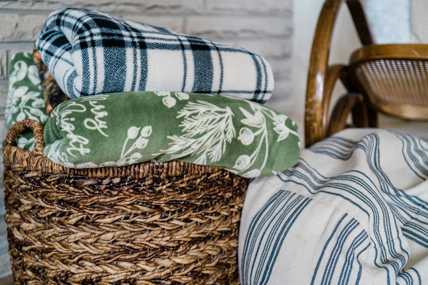 Folded blankets stored in a woven basket