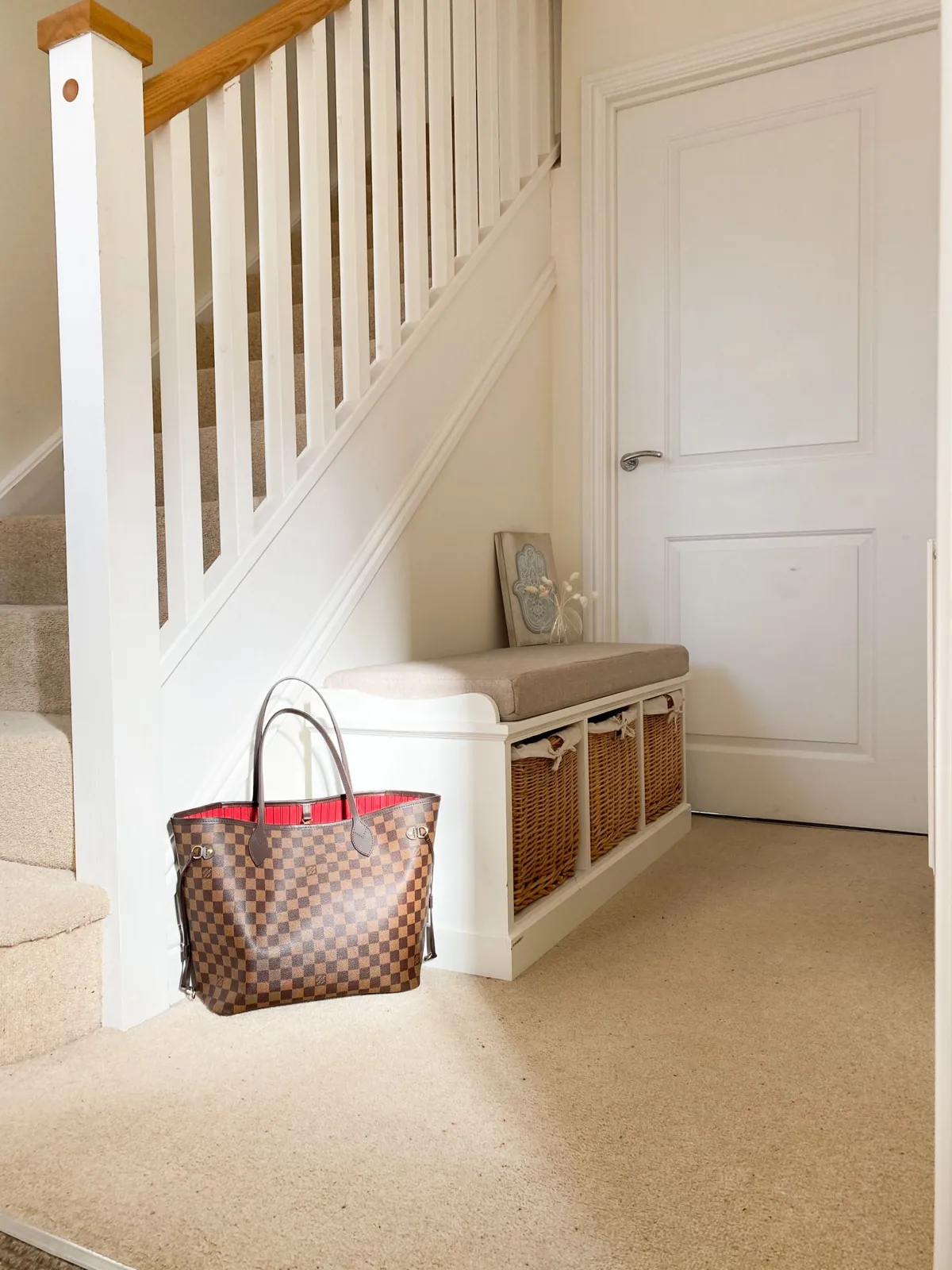 Entryway bench with storage baskets beneath the seat